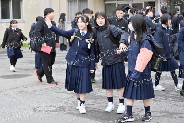 「行ってきます」－。見送りに来た保護者に手を振る帯広第二中の生徒（８日午前７時半ごろ、須貝拓也撮影）