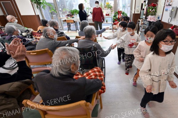 施設利用者と握手を交わしながら退場する園児（５日午前１０時４５分ごろ、須貝拓也撮影）