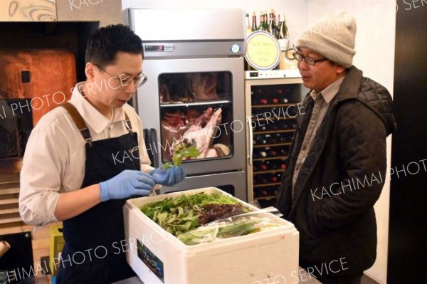 宇佐美さん（右）から週に１度野菜を仕入れる小久保シェフ