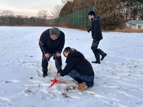 秋山教授のアドバイスを受けながら、モデルロケットの打ち上げ準備をする生徒たち（提供写真）