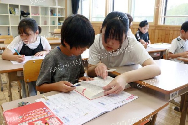 高校生の指導を受けながら、勉強に取り組む児童ら