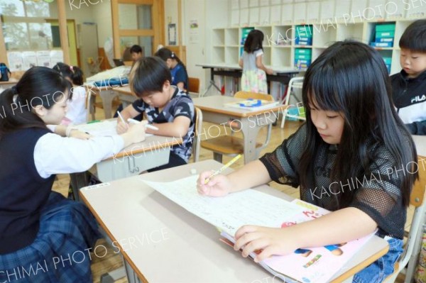 高校生の指導を受けながら、勉強に取り組む児童ら