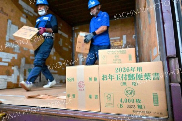 コンテナから次々と降ろされる年賀はがきが入ったダンボール箱（２日午前９時ごろ。帯広郵便局で。金野和彦撮影）