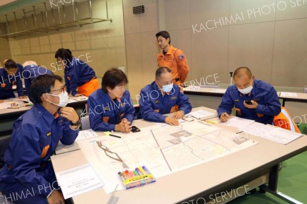 災害を想定し、本部と無線で連絡を取り合う団員たち