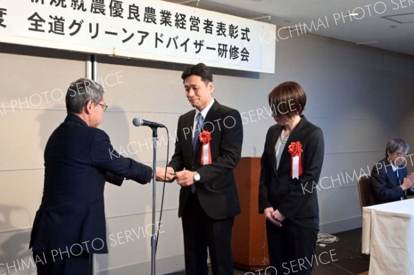 表彰盾を受け取る