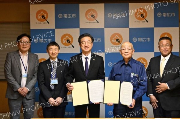協定を取り交わし記念撮影する市と組合の関係者