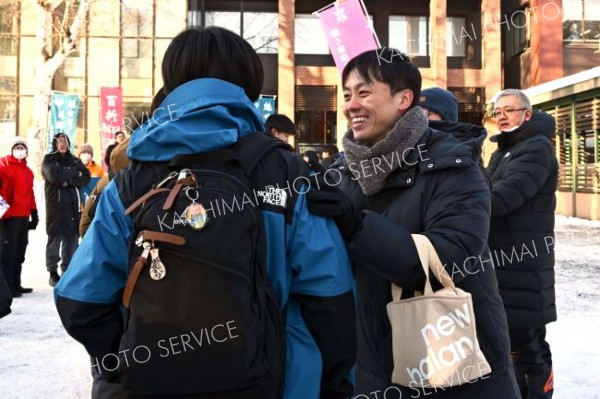 試験会場に入る受験生を励ます高校教員ら（１７日午前９時半ごろ、帯広畜産大学で。塩原真撮影）