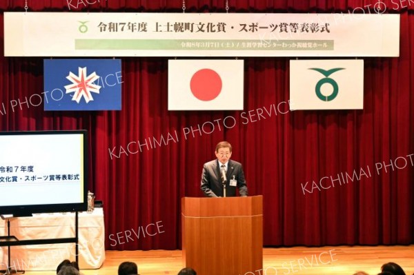 表彰式であいさつする